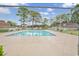 Inviting fenced community pool on a sunny day with lush landscaping at 1025 Carolina Rd. # I-7, Conway, SC 29526
