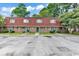 Two-story brick townhomes with parking and grassy front yards at 1025 Carolina Rd. # I-7, Conway, SC 29526