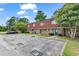Charming brick townhouse featuring a red roof, green doors, and assigned parking at 1025 Carolina Rd. # I-7, Conway, SC 29526