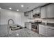 Modern kitchen with gray cabinets, granite countertops, and stainless steel appliances at 1060 Manassas Dr., Conway, SC 29526