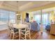 Bright dining area with white table and chairs, adjacent to living room at 11 Inlet Point Dr., Pawleys Island, SC 29585