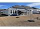A home with outdoor space featuring a screened in patio and awnings in a well-maintained yard at 1519 Wood Stork Dr., Conway, SC 29526