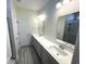 Modern bathroom with double sinks, quartz countertops, and a tiled shower at 1519 Wood Stork Dr., Conway, SC 29526