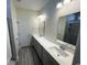 Spacious bathroom with double sinks, a large mirror, and a tiled shower with glass door at 1519 Wood Stork Dr., Conway, SC 29526