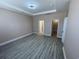Bright, open bedroom featuring wood-look floors and multiple entry points at 1519 Wood Stork Dr., Conway, SC 29526