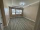 Spacious bedroom with tray ceiling, wood-look flooring, and large window at 1519 Wood Stork Dr., Conway, SC 29526
