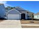 Charming single-story home with a well-manicured front lawn and a two-car garage at 1519 Wood Stork Dr., Conway, SC 29526