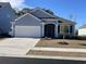 Beautiful home with a well-maintained yard, driveway, and lovely exterior details at 1519 Wood Stork Dr., Conway, SC 29526