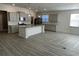 Well-lit kitchen with an island, stainless steel appliances, gray cabinets, and granite countertops at 1519 Wood Stork Dr., Conway, SC 29526