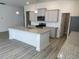 Charming kitchen featuring gray cabinets, granite countertops, and a center island with a sink at 1519 Wood Stork Dr., Conway, SC 29526