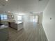 Open-concept living room and kitchen with gray plank flooring and plenty of natural light at 1519 Wood Stork Dr., Conway, SC 29526