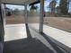 Relaxing screened-in porch with tile flooring, offering views of the yard and an ideal space for outdoor living at 1519 Wood Stork Dr., Conway, SC 29526