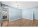 Spacious bedroom with light blue walls, wood floors, and access to bathroom at 1600 Gibson Ave., Myrtle Beach, SC 29575