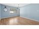 Light blue bedroom with wood floors and large window at 1600 Gibson Ave., Myrtle Beach, SC 29575