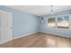 Bedroom with light blue walls, wood floors, and a window view at 1600 Gibson Ave., Myrtle Beach, SC 29575