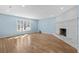 Living room with light blue walls, wood floors, and white brick fireplace at 1600 Gibson Ave., Myrtle Beach, SC 29575
