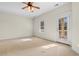 Well-lit bedroom featuring a ceiling fan and private balcony access at 171 Beaufain Ct., Pawleys Island, SC 29585