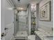 Elegant bathroom with a large walk-in shower and marble tile at 1990 N Waccamaw Dr. # 1109, Garden City Beach, SC 29576