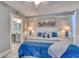 King-size bed, ceiling fan, and ensuite bathroom in this bright bedroom at 1990 N Waccamaw Dr. # 1109, Garden City Beach, SC 29576