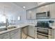 Modern kitchen with stainless steel appliances and gray cabinets at 1990 N Waccamaw Dr. # 1109, Garden City Beach, SC 29576