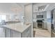 Open concept kitchen with stainless steel appliances and white quartz counters at 1990 N Waccamaw Dr. # 1109, Garden City Beach, SC 29576