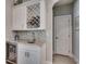 Stylish bar area features custom wine rack, mosaic backsplash, granite countertop and beverage fridge at 2004 Via Palma Dr., North Myrtle Beach, SC 29582