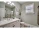 Bathroom featuring a marble vanity, toilet, and shower with glass doors at 2004 Via Palma Dr., North Myrtle Beach, SC 29582