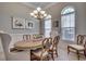 Elegant dining room boasting a chandelier, wainscoting, and natural light at 2004 Via Palma Dr., North Myrtle Beach, SC 29582