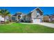 Charming home featuring lush green lawn, manicured landscaping, and a two-car garage at 2004 Via Palma Dr., North Myrtle Beach, SC 29582