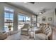 A stylish living area featuring comfortable seating and large windows overlooking the outdoor patio and pool at 2004 Via Palma Dr., North Myrtle Beach, SC 29582