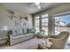Comfortable living room features a sofa, chairs, and large windows offering plenty of natural light at 2004 Via Palma Dr., North Myrtle Beach, SC 29582