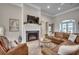 Inviting living room featuring fireplace, leather furniture, and neutral décor at 2004 Via Palma Dr., North Myrtle Beach, SC 29582