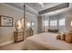 Luxurious main bedroom featuring a four-poster bed, dresser with mirrors, and window seat at 2004 Via Palma Dr., North Myrtle Beach, SC 29582