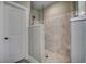 Modern walk-in shower featuring marble-look tile and glass enclosure at 2004 Via Palma Dr., North Myrtle Beach, SC 29582