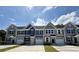 New townhomes featuring an attached one car garage and a concrete driveway against a sunny blue sky at 2065 Nw Parow Ln Nw # D, Calabash, NC 28467