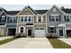 New townhomes featuring an attached one car garage and a concrete driveway with a dark roof at 2065 Nw Parow Ln Nw # D, Calabash, NC 28467