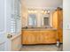 Bathroom with double vanity, granite countertop and large mirror at 2179 South Waccamaw Dr., Garden City Beach, SC 29576