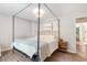 Main bedroom with a four-poster bed, hardwood floors, and access to the bathroom at 245 Windover Dr., Pawleys Island, SC 29585