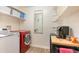 Bright laundry room with washer, dryer, and extra shelving at 245 Windover Dr., Pawleys Island, SC 29585