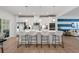 Modern kitchen with white cabinets, island with seating, and stainless steel appliances at 2557 Pete Dye Dr. # 903, North Myrtle Beach, SC 29582