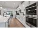 Bright kitchen featuring white cabinets, stainless steel appliances, and hardwood floors at 2557 Pete Dye Dr. # 903, North Myrtle Beach, SC 29582