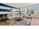 Spacious living room with white sofas and blue accent wall at 2557 Pete Dye Dr. # 903, North Myrtle Beach, SC 29582