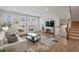 Living area features white sofas, large TV, and hardwood floors at 2557 Pete Dye Dr. # 903, North Myrtle Beach, SC 29582