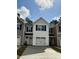 Exterior view of a two-story townhome featuring a garage, driveway, and neutral siding at 265 Christiana Ln. # B, Myrtle Beach, SC 29579