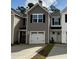 New construction homes featuring attached garages and neutral color schemes on a sunny day at 265 Christiana Ln. # C, Myrtle Beach, SC 29579