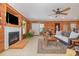 Living room with wood walls, fireplace, and comfy seating at 3658 Edwards Rd., Aynor, SC 29511