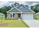 Charming single-Gathering home showcasing a stone facade and a well-manicured lawn at 392 Clear Lake Dr., Conway, SC 29526