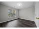 Spacious bedroom with hardwood floors and window at 4239 Villas Dr. # 609, Little River, SC 29566