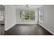 Living room with hardwood floors and large windows at 4239 Villas Dr. # 609, Little River, SC 29566