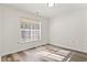 Bright bedroom with large window and wood-look floors at 4251 Villas Dr. # 303, Little River, SC 29566